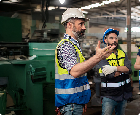 Man in hard hat explaining something to another man in a hard hat