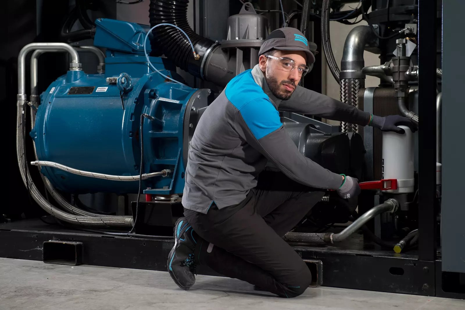 Service technician troubleshooting an air compressor system