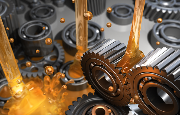 oil being poured over gears and cogs 