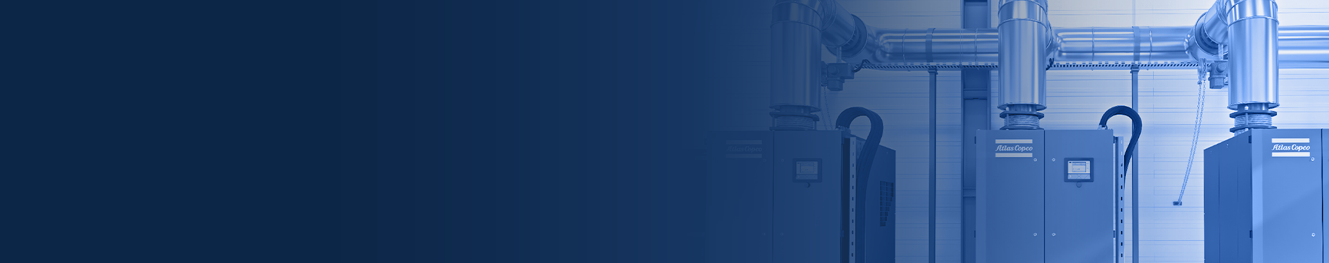 atlas copco air compressors piped together on a factory floor with dark blue overlay