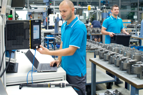 technicians on a factory floor performing production activities