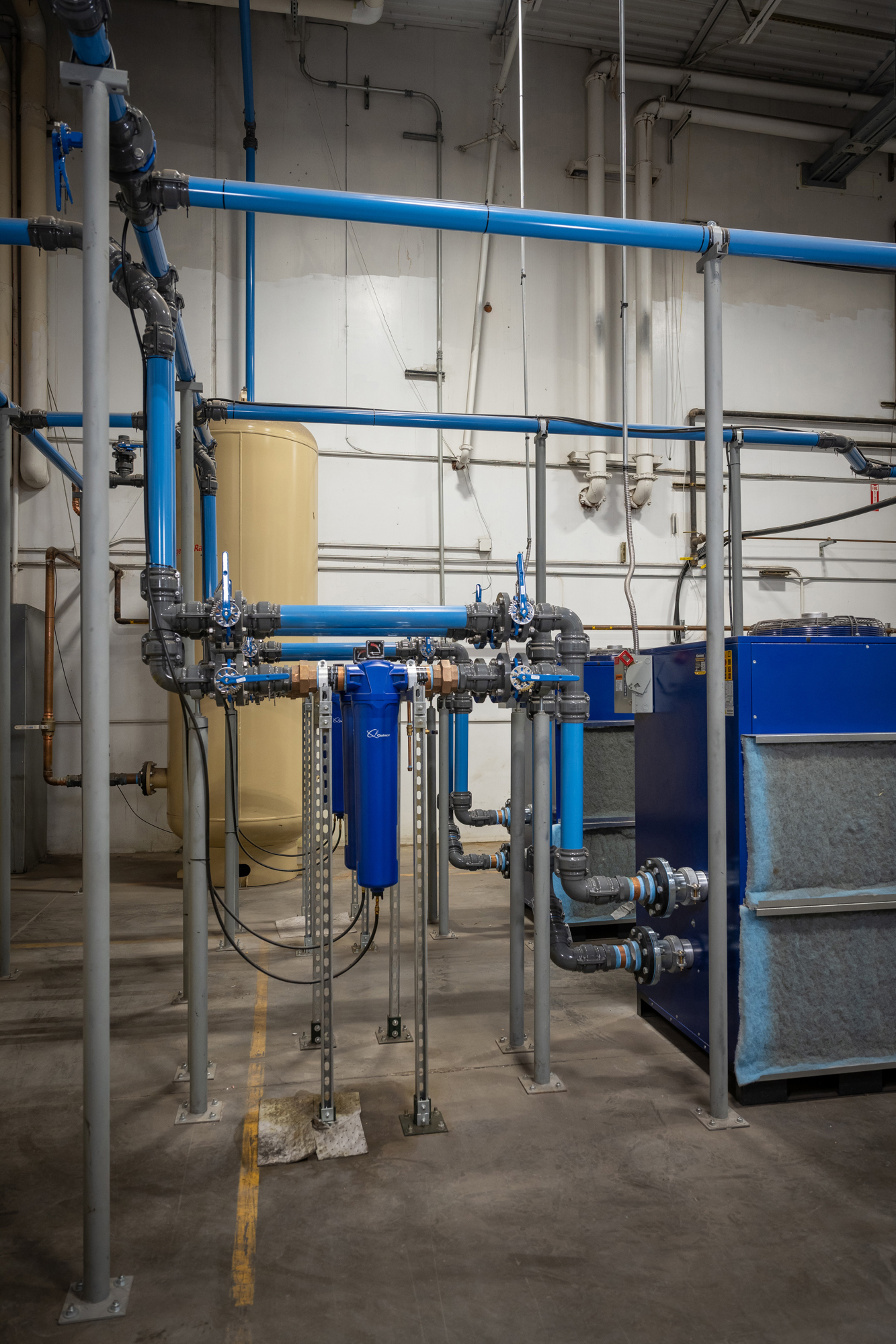 compressed air piping in factory with elbows and an inline filter