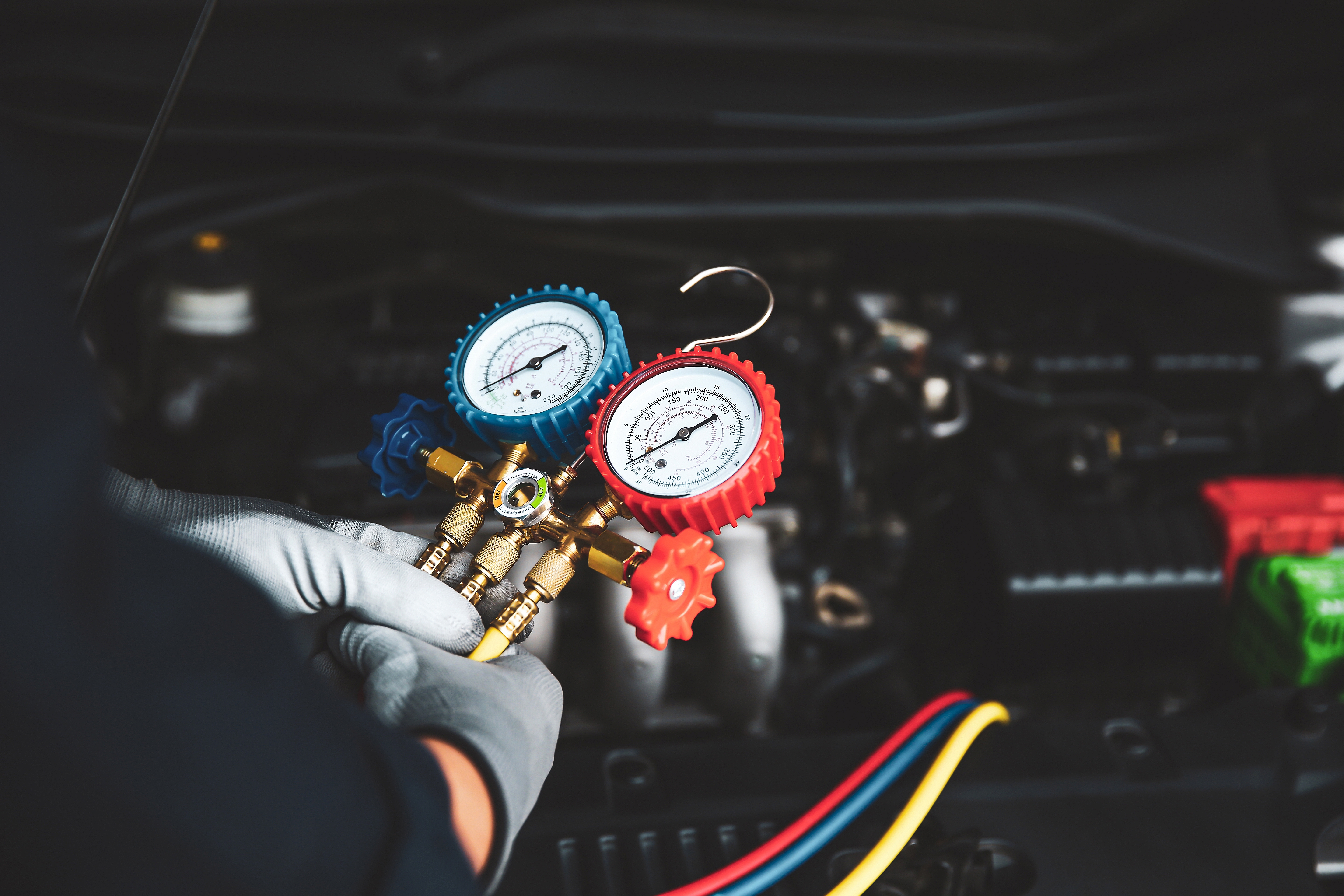technician checking pressure gage