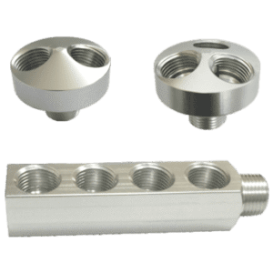Set of three silver colored metal threaded manifolds in various configurations.