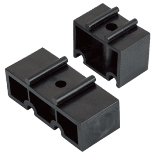 Dark Grey spacer blocks meant to bridge the gap between the mounting surface and pipe clips