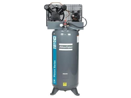 Atlas copco air compressor piston style mounted on a grey vertical tank