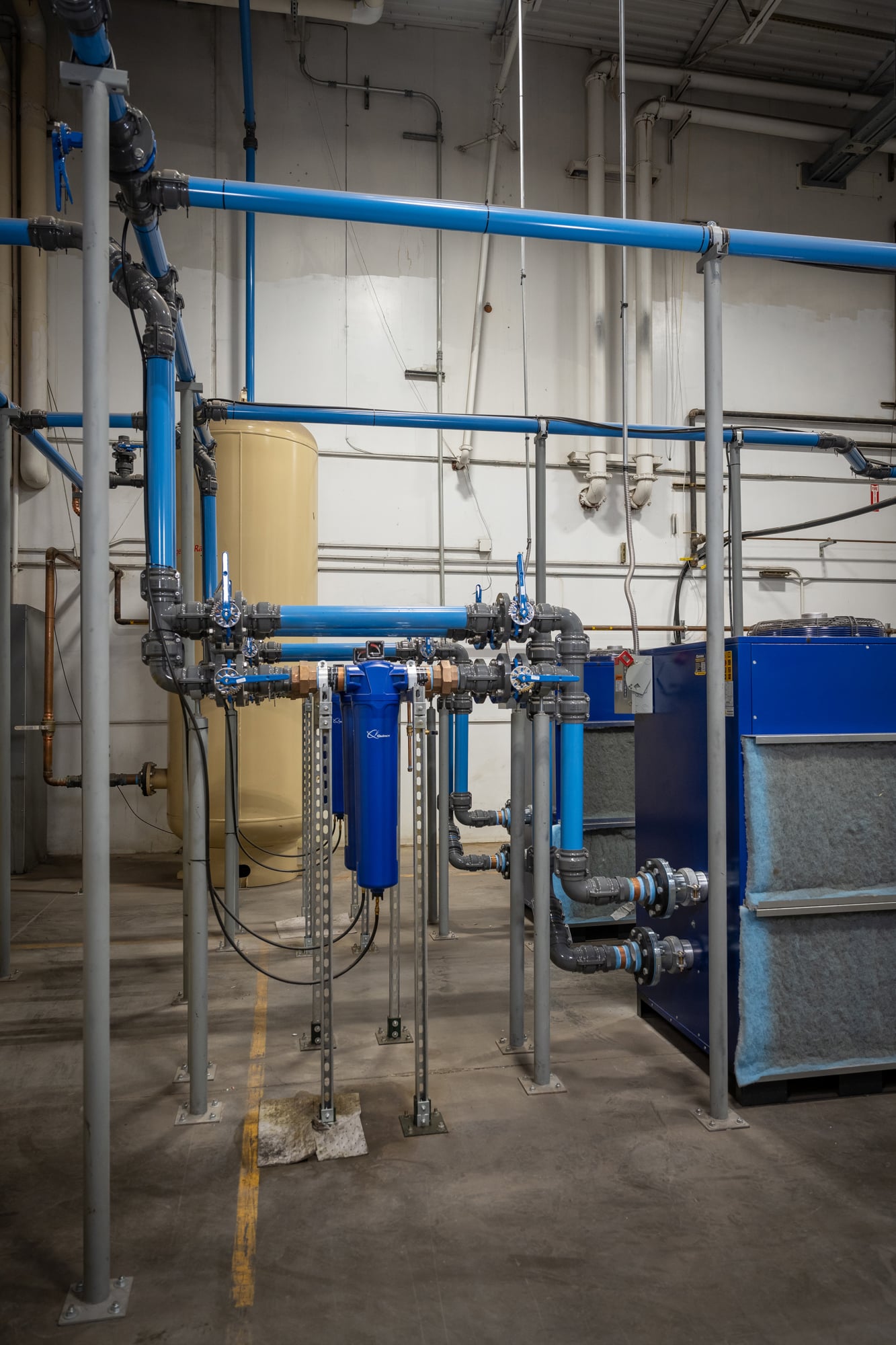 compressed air piping in factory with elbows and an inline filter